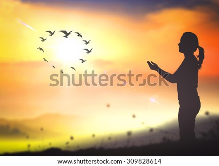 Silhouette beautiful woman and birds flying in the shape of heart. Blessing, Elimination of violence against women, International Day of Zero Tolerance to Female Genital Mutilation, Valentine concept.