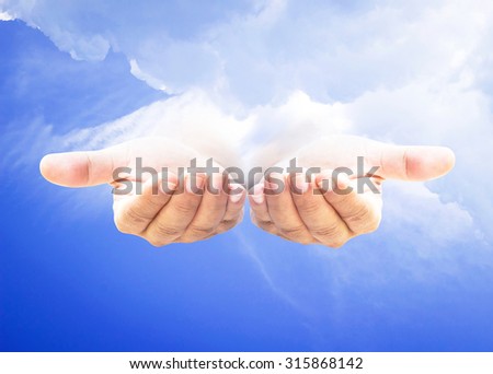 Human open empty hand with palms up over amazing sky background. Hand of God concept.