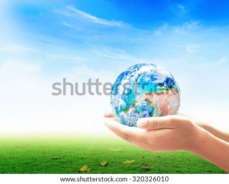 Planet in human hands on beautiful nature background. environment concept. World Mental Health Day concept. Elements of this image furnished by NASA.