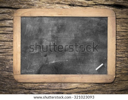 Blank old wooden blackboard or dirty slate board with white chalk.