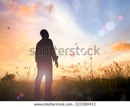 Silhouette human standing over beautiful  golden autumn sunset background.  World Mental Health Day concept.