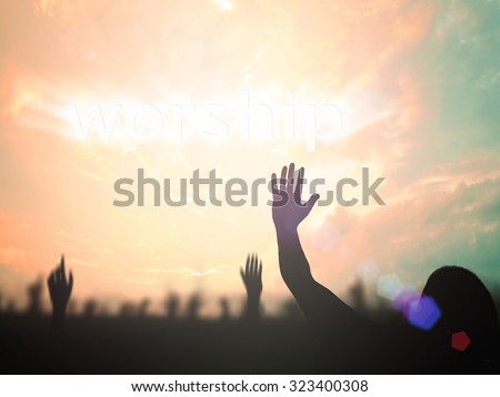 Silhouette people raising hands over blurred text for WORSHIP on beautiful nature background. Good Friday, Easter Sunday, Holy Week, He is risen concept.