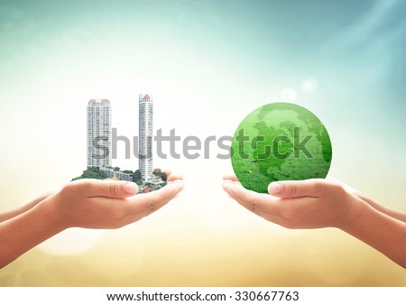 First, human hand holding the city. Second, human hand holding a green earth of grass  over blurred nature background. Ecological City, World Environment Day concept.