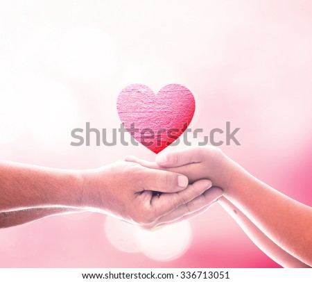 Two human hand hold red heart. Valentines Day Love Christmas Organ Donation Marriage Gift Generosity Harmonious Gift Hope Share Dream Wish Dating World Cupid Giving New God Graft Family Cancer concept