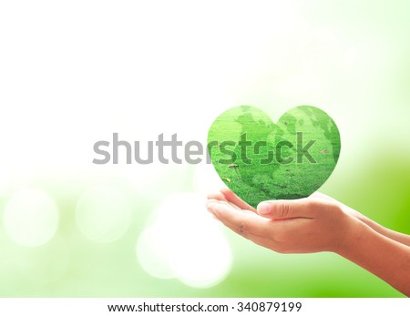 Heart green earth globe of grass in human hands on blurred beautiful bokeh background. Environment Mission Organ Donation Medical Health Care Medical Family Connection Search Healthy Spring concept.