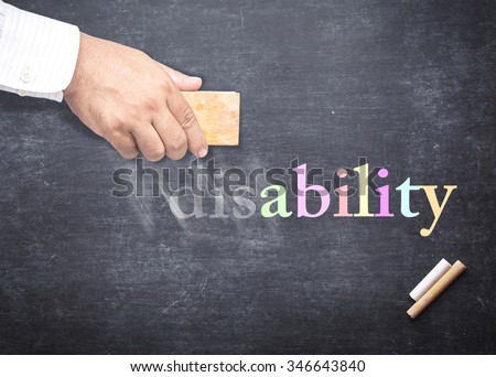 Businessman hand erased alphabet d, i, s from a chalkboard for changing to ABILITY. The word DISABILITY erased from a chalkboard. Concept of International Day of Persons with Disabilities, Can, Trust.