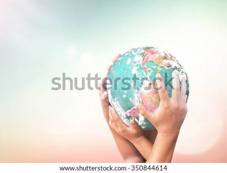 Hand holding globe. International Solidarity World Cancer Together Unity Synergy Love Valentine\'s Day CSR Investment Map Spring Time Languages Justice concept. Elements of this image furnished by NASA
