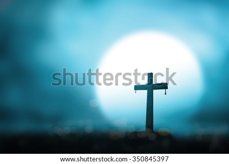 Silhouette cross on blur night light background. Merry Christmas Card Thankful Adoration Glorify Peace Hallelujah Blessing Amen Hope Religion Full Moon Redeemer Redemption Love God Pentecost concept