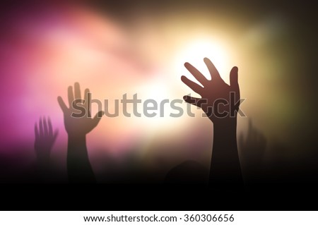 Silhouette people raising hand on blurred colorful light background. Worship, Forgiveness, Mercy, Humble, Evangelical, Hallelujah, Thankful, Praise, Redeemer, Amen, Human Rights Day, Humanity concept