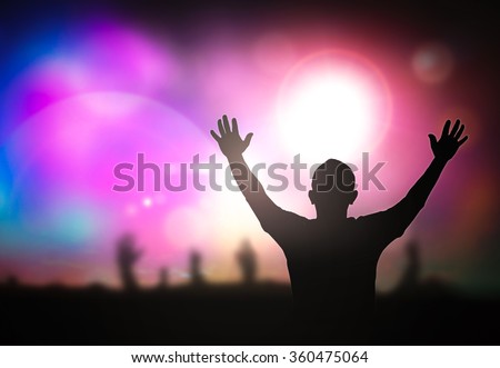 Silhouette people raising hands on blurred colorful light background. Worship, Forgiveness, Mercy, Humble, Evangelical, Hallelujah, Thankful, Praise, Redeemer, Amen, Human Rights Day, Humanity concept