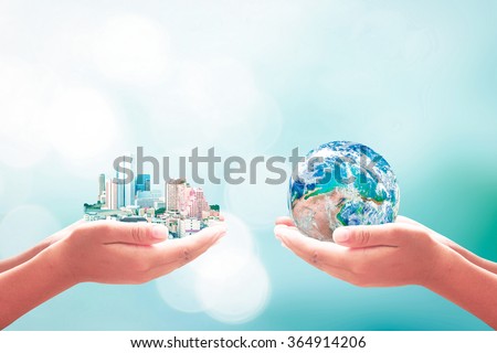 Two human hand hold beautiful big city and blue planet. Ecological, World Environment Day, Sustainable Development, Quality, Finance, Learning, CSR concept. Elements of this image furnished by NASA.
