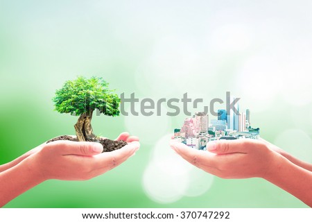 Two human hands holding the city and big tree. Ecological City, World Environment Day, Sustainable Development, ROI, Go Green, Eco Friendly, Ecofriendly, Trust, New Life, Marketing, business concept.