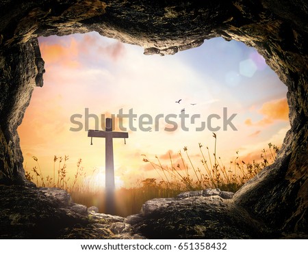 Resurrection of Jesus Christ concept: Tomb empty with cross at sunrise.