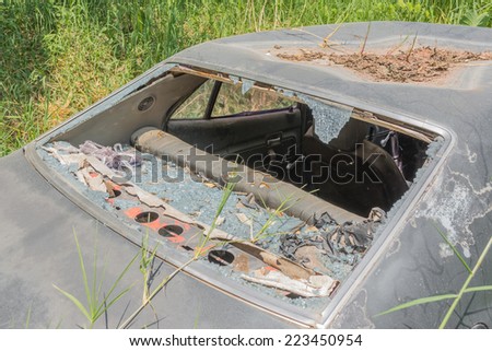 image of Old Dirty Car with Busted Window.