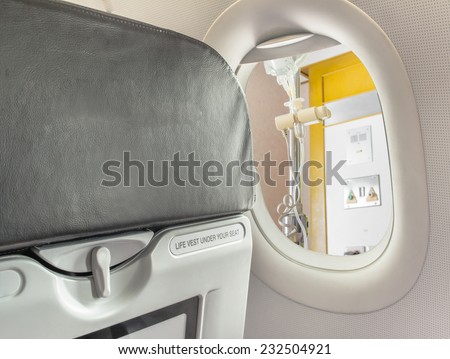 image of  fasten seat belt while seated sign on airplane.