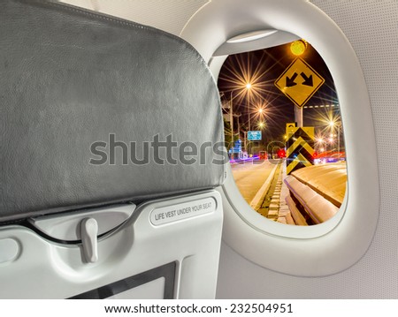 image of  fasten seat belt while seated sign on airplane.