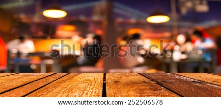 empty brown wooden table and  Coffee shop blur background with bokeh image