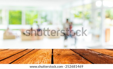 Empty wood table and Coffee shop blur background with bokeh image.