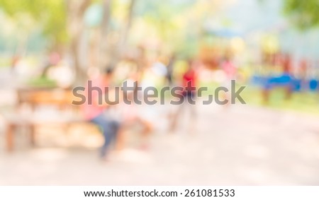 Blur background image of people activities in public park with bokeh .