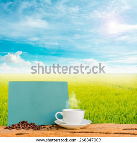 image of coffee cup and  rice field with clear blue sky for background usage .