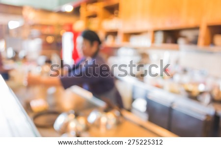 blur image of Japanese chef making food in kitchen for background usage .