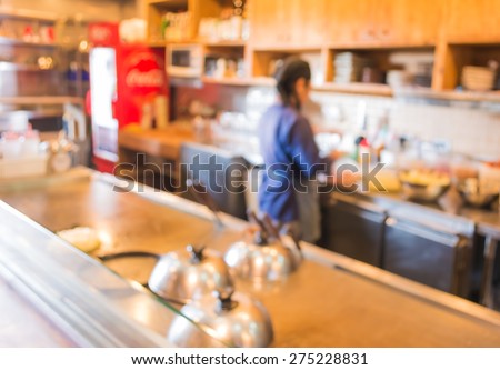 blur image of Japanese chef making food in kitchen for background usage .