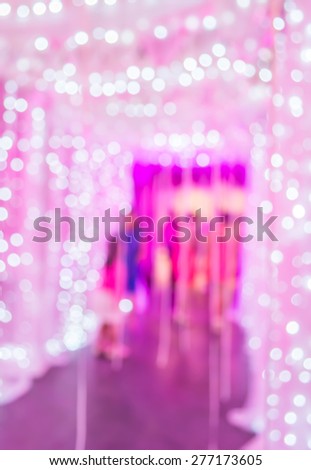 Blurred motion image of people moving to the lights gate indoor