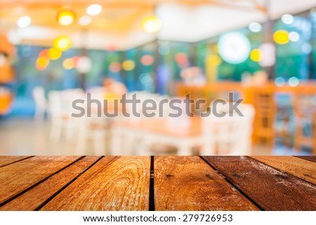 image of  Perspective wood and blurred coffee shop with bokeh light background. product display template.
