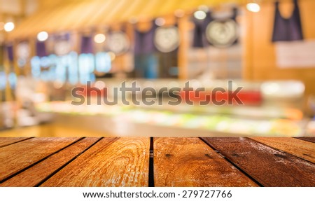 blur image of Abstract blurry sushi counter in vintage style decoration restaurant.