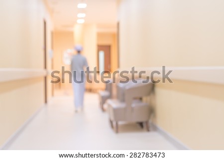 blur image of nurse in hospital walkway for background usage.