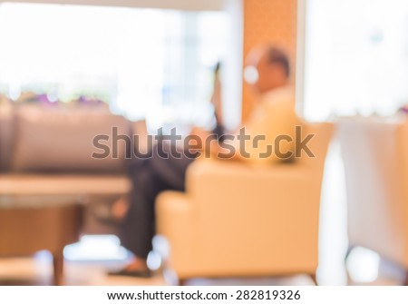 blur image of old man in hospital office room with table and chairs for background usage.