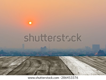 Hazy skyline of Chiang Mai City ,Thailand smog covering buildings with sunrise .