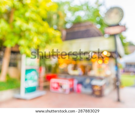 blurred image of outdoor coffee shop on day time for background usage.