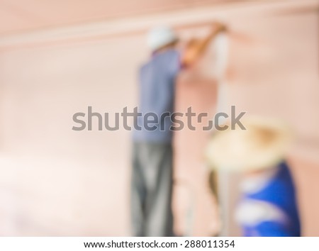blur image of people  fixing house wall for background usage.