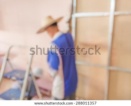 blur image of people  fixing house wall for background usage.