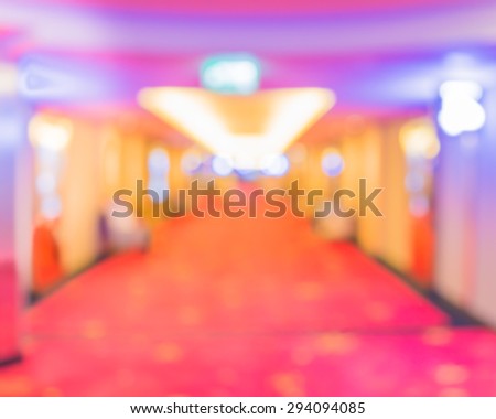 blurred image of people at cinema's corridor for background usage .
