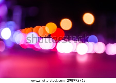image of blur street  bokeh  with purple tone lights in night time for background usage .