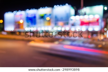 image of blur street  and billboard  with warm colorful lights in night time for background usage .