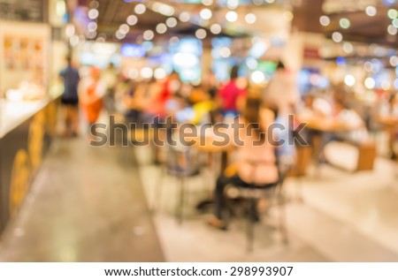 image of blur people at food court in mall for background usage .