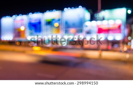 image of blur street  and billboard  with warm colorful lights in night time for background usage .