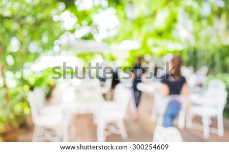 image of blur outdoor restaurant on day time with green tree bokeh for background usage .