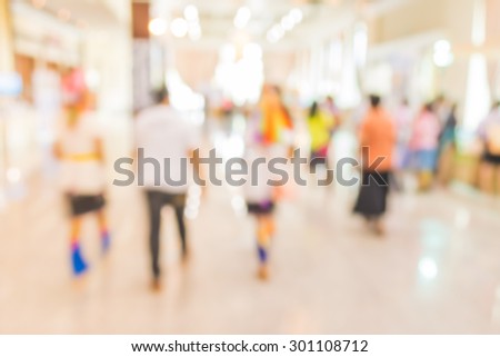 blurred image of shopping mall and people for background usage .