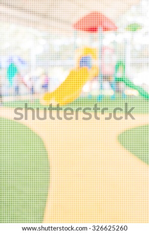 Defocused and blur image of children's playground at public park for background usage.(dot Pattern Pixelation effect image)