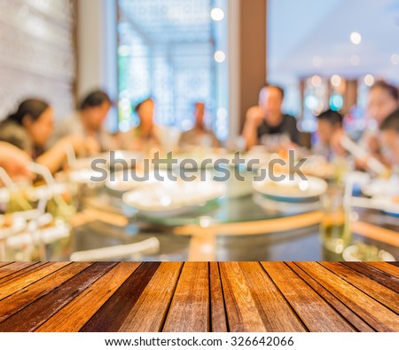 wood table and Chinese restaurant blur background with bokeh image .