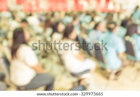 image of blur people looking to kid 's show on stage at school , for background usage . (vintage tone)