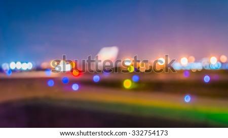 blur image of runway in night time with bokeh for background usage.