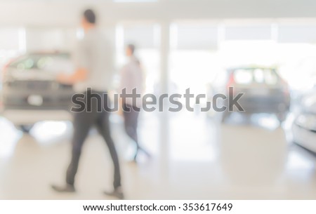 blur image of Commercially cars stand in show room of car shop for background usage .