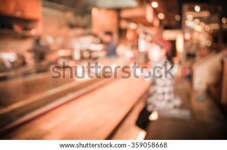 blur image of Abstract blurry sushi counter and customer  in vintage style decoration restaurant.