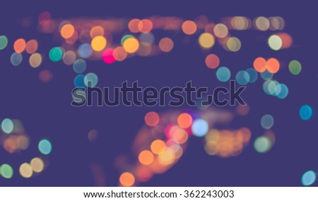 image of blurred bokeh background with warm colorful lights . (vintage tone)