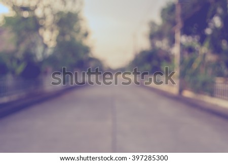 vintage tone image of blur walkway with sunny day in park for background usage .
